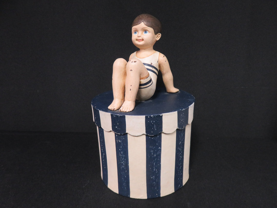 Boy on Striped Box